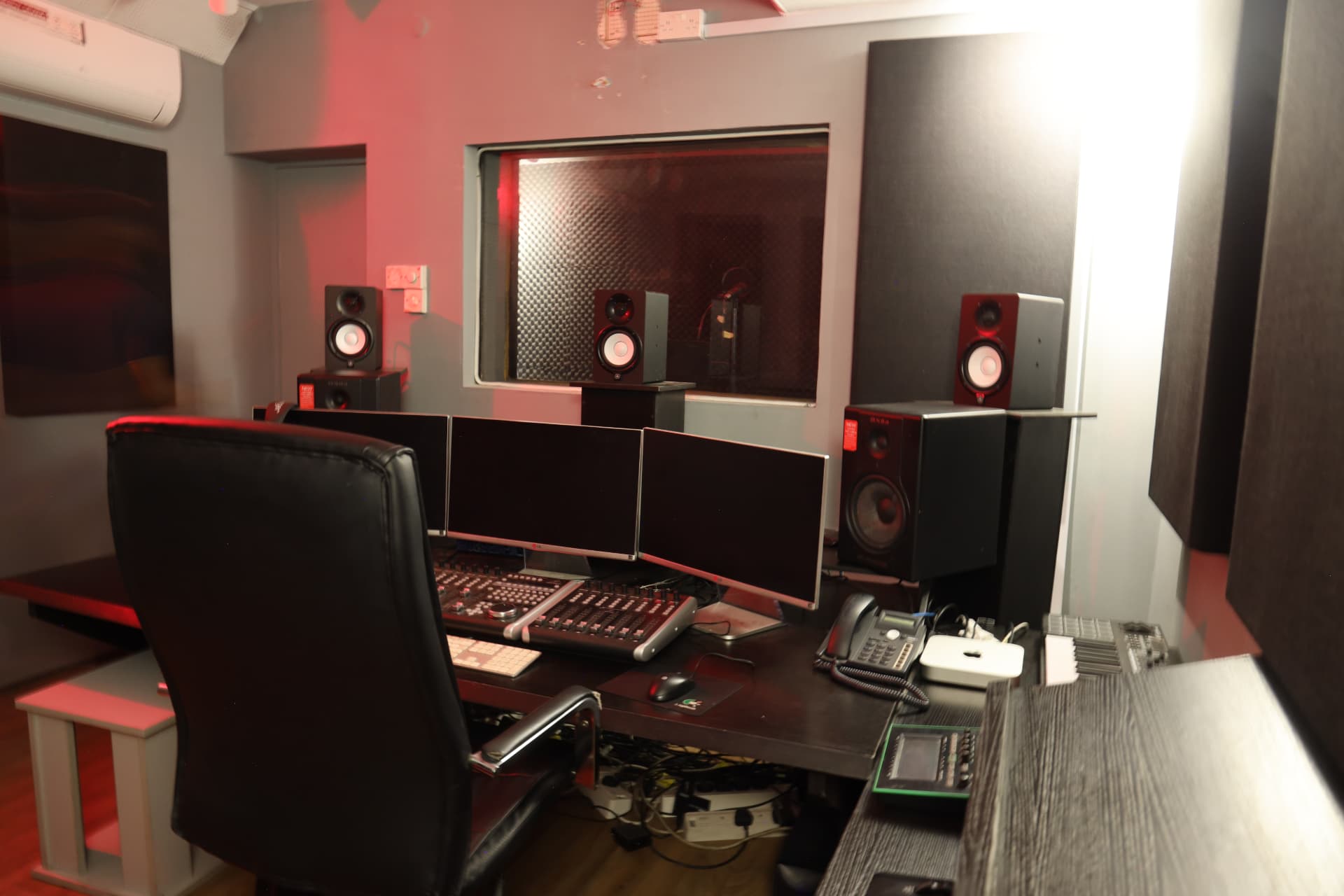 Side view of Sound Suite 2 control room showing mixing console, speakers and acoustic paneling