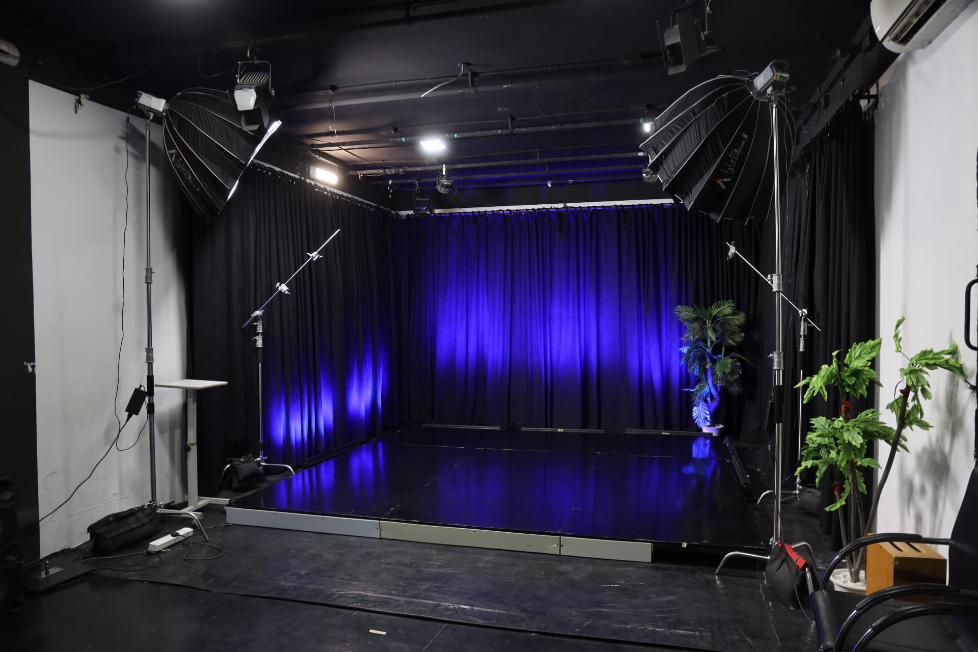 Studio B floor from a higher angle showing the lit stage, softboxes and overhead LED grid