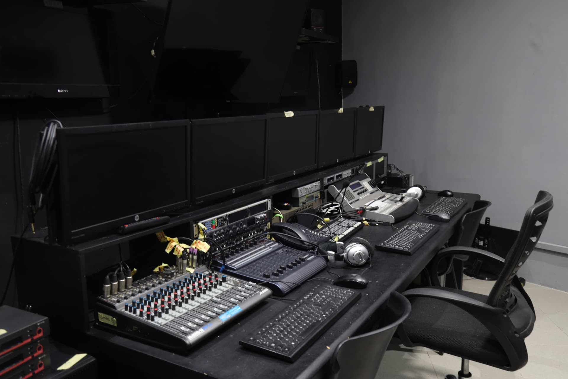 Control Room B at Digitrack Studios with broadcast desk, Alesis mixer and multi-monitor setup